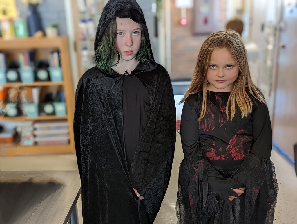  Two girls dressed in all black costumes